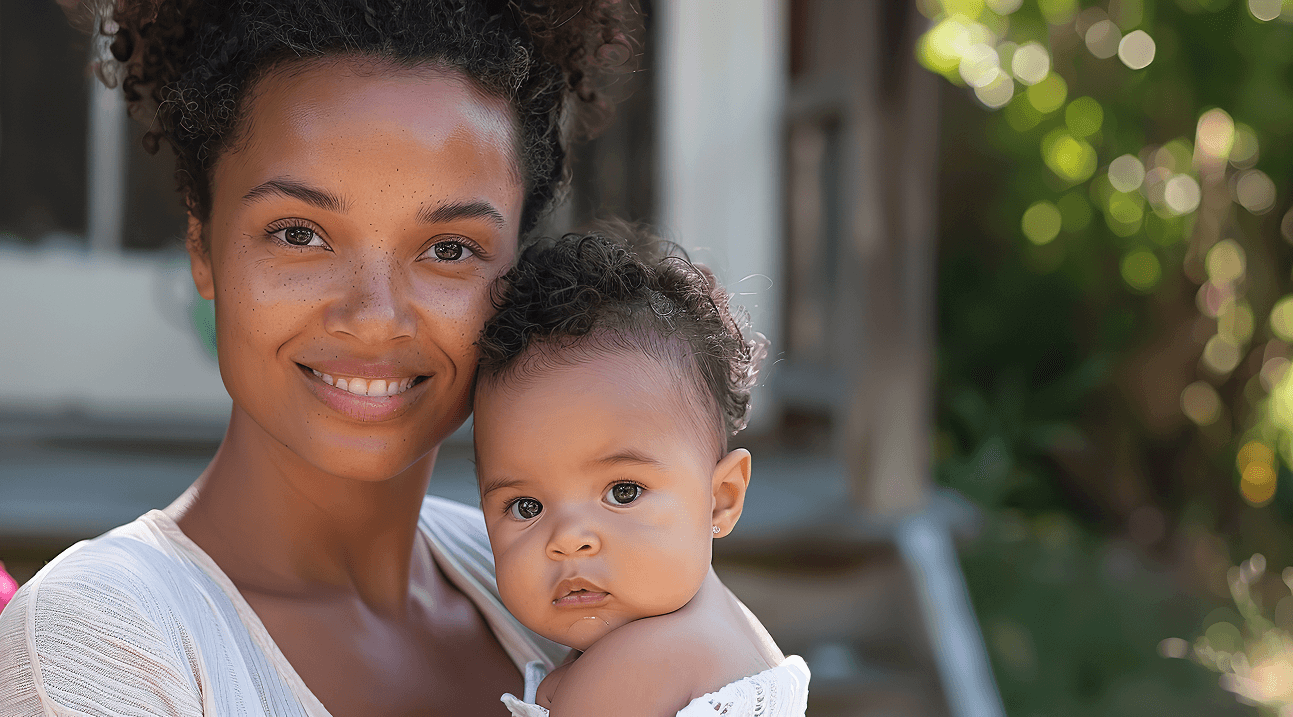 Mother holding her baby in warm sunlight